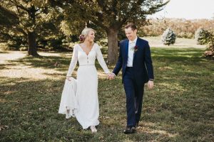 couple walking in wedding attire