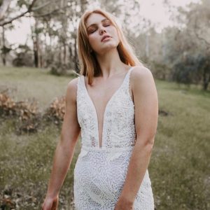 woman in unique lace fitted wedding gown