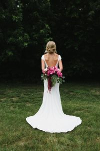 woman in simple wedding dress with low back