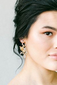 woman wearing leafy drop earrings