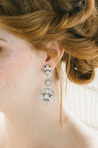 woman in drop opal earrings
