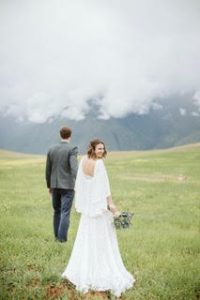 bride and groom in front of the mountains