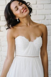 woman in thin beaded sash