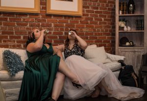bride and maid of honor drinking and celebrating