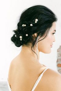 pearl hair pins scattered throughout a low updo