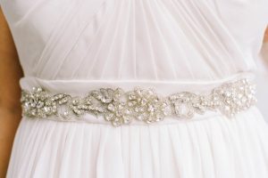 silver sash on a wedding dress