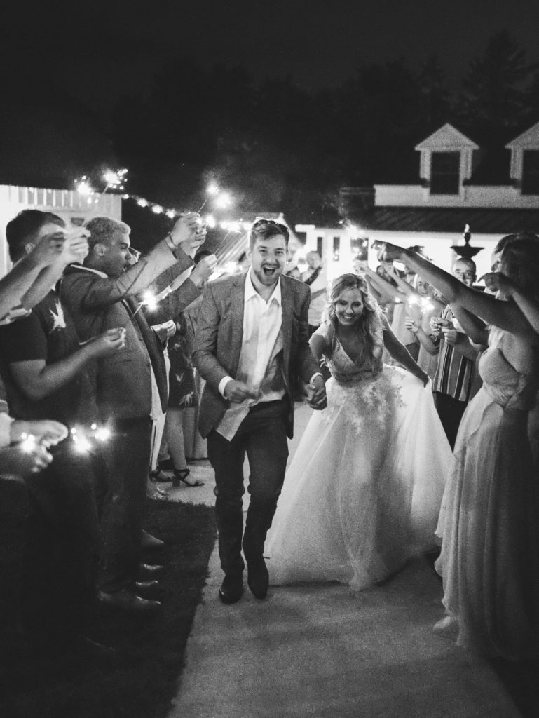bride and groom leaving reception with a sparkler exit