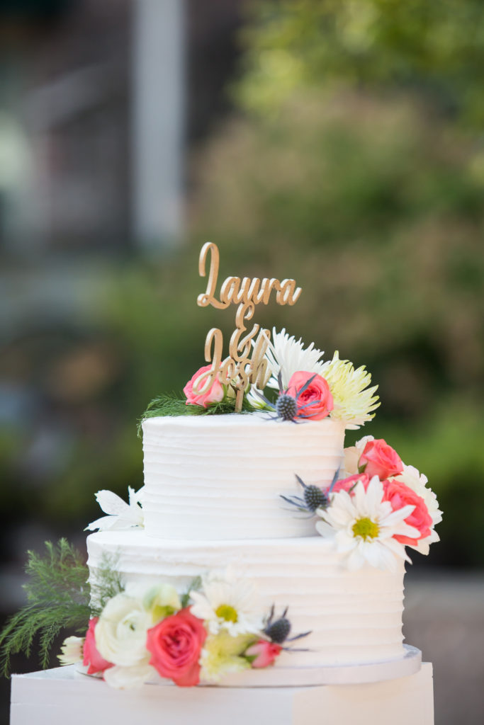 wedding cake with "laura and josh" topper