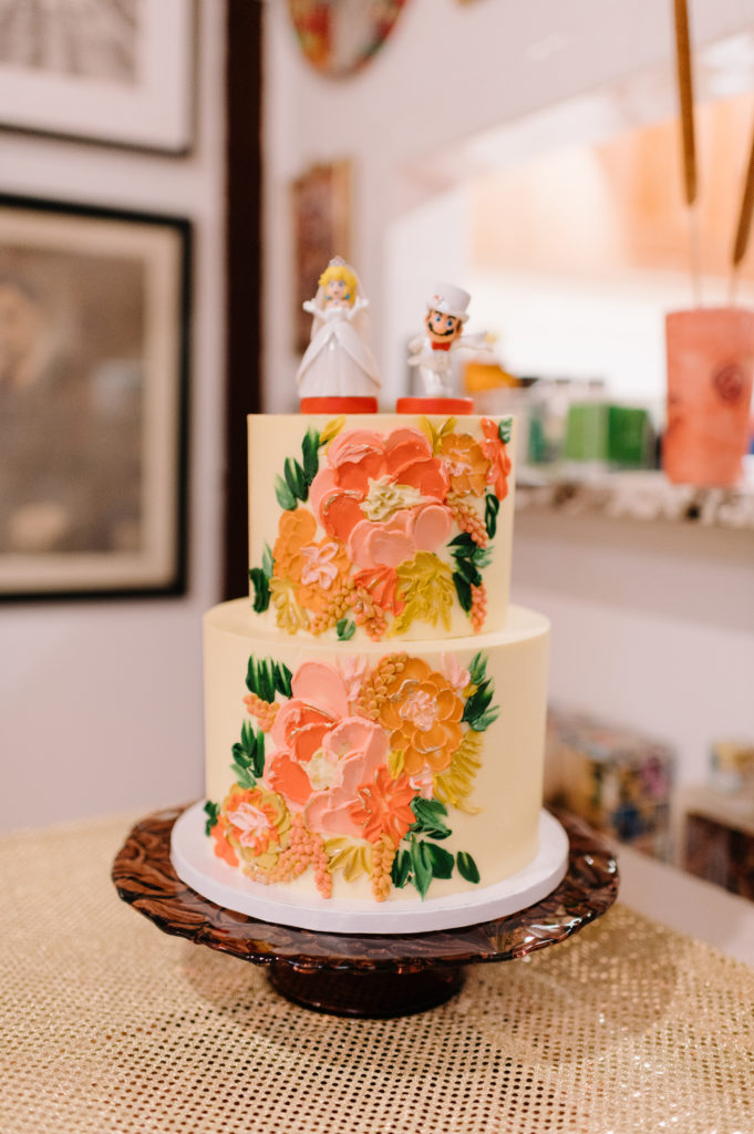 floral wedding cake with Mario and Princess Peach on the top